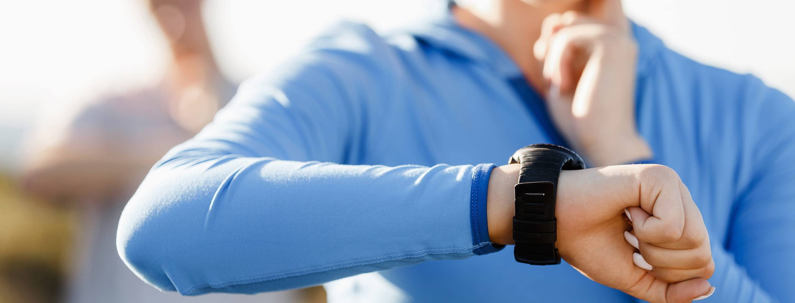Woman monitoring her heart rate with smart watch